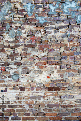 Multicolored red bricks with grey and white mortar