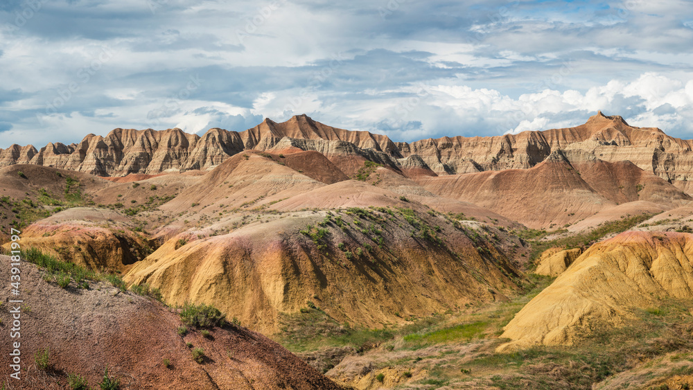 Yellow mounds and colorful red rocks and dramatic mountains in the Badlands National Park - South Dakota