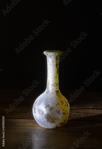 Glass vase artifact from Israel on a black background.