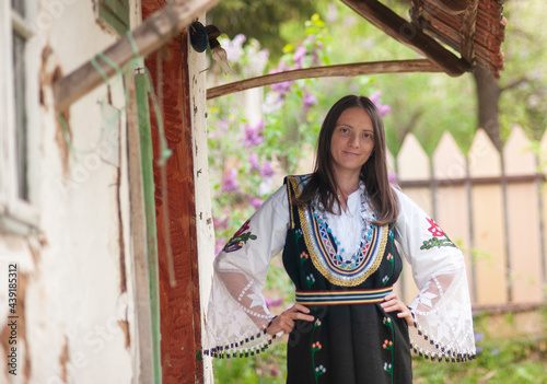 A young woman is posing in a traditional Serbian handmade outfit Litak (narodna nošnja Litak) photo