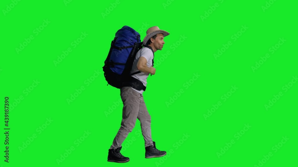 Hiker in cowboy hat with backpack walking on green screen background, Side view, chroma key 4k footage Hiker in cowboy hat with backpack walking on green screen background, Side view, chroma key 4k footage