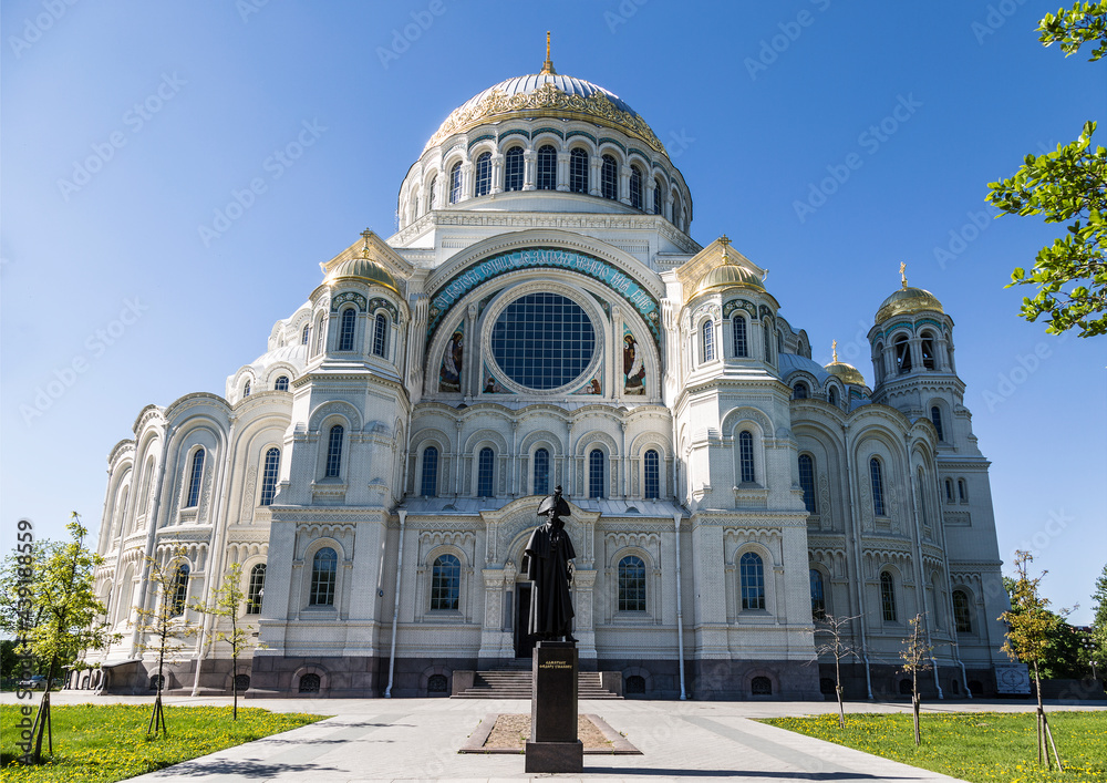 Sea Cathedral of St. Nicholas with a monument to the famous Russian admiral Fyodor Ushakov in the foreground in Kronstadt, St. Petersburg, Russia