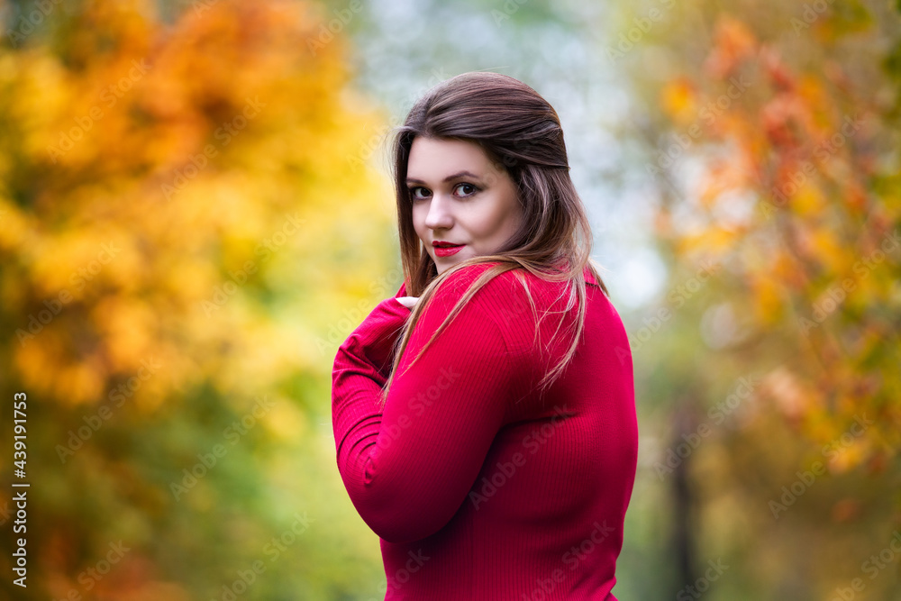 Sexy beautiful woman in autumn, cute plus size model in red sweater outdoors Sexy beautiful woman in autumn, cute plus size model in red sweater outdoors
