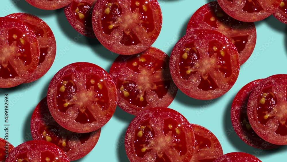 Two layers of tomato slices in geometric pattern on a pale blue ...