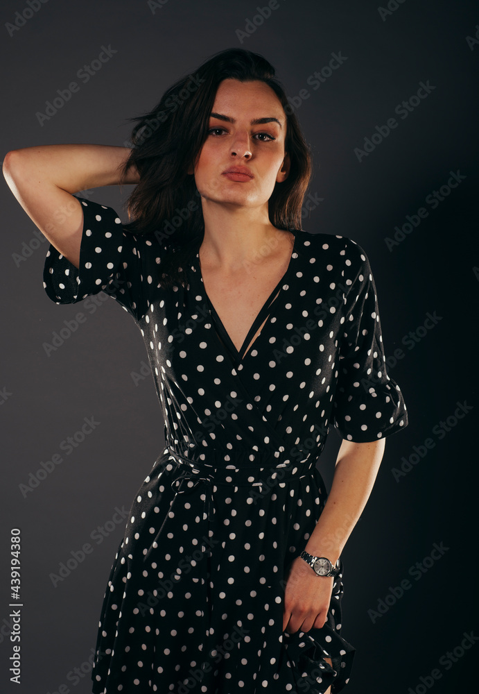 Fashion model girl dressed in short satin dress. Full length portrait