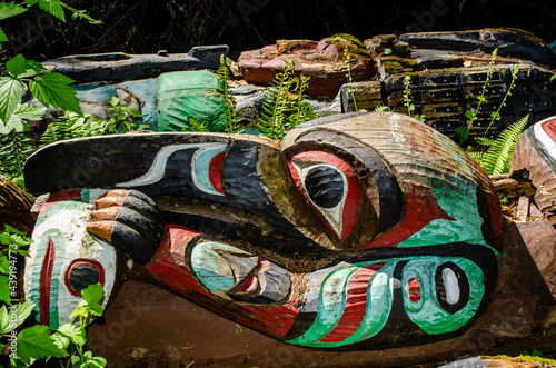 Bird of the Totem Pole - The head of a bird with the arms of a man decorate a fallen totem pole with vivid colours