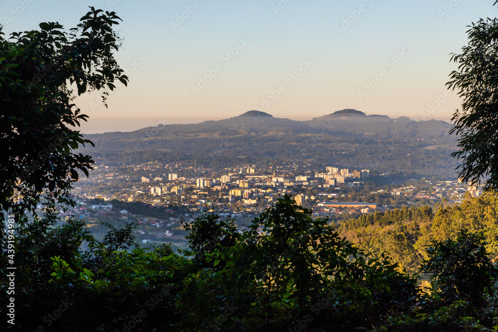 View with small city, mountains and forest
