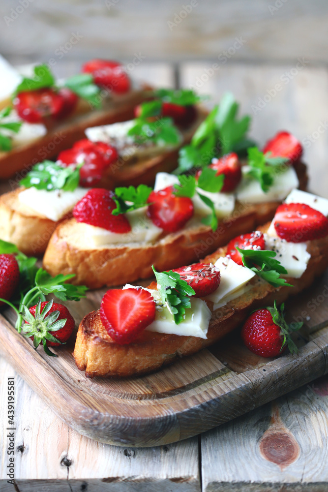 Beautiful strawberry toast with white cheese. Strawberry bruschetta. A healthy summer snack.