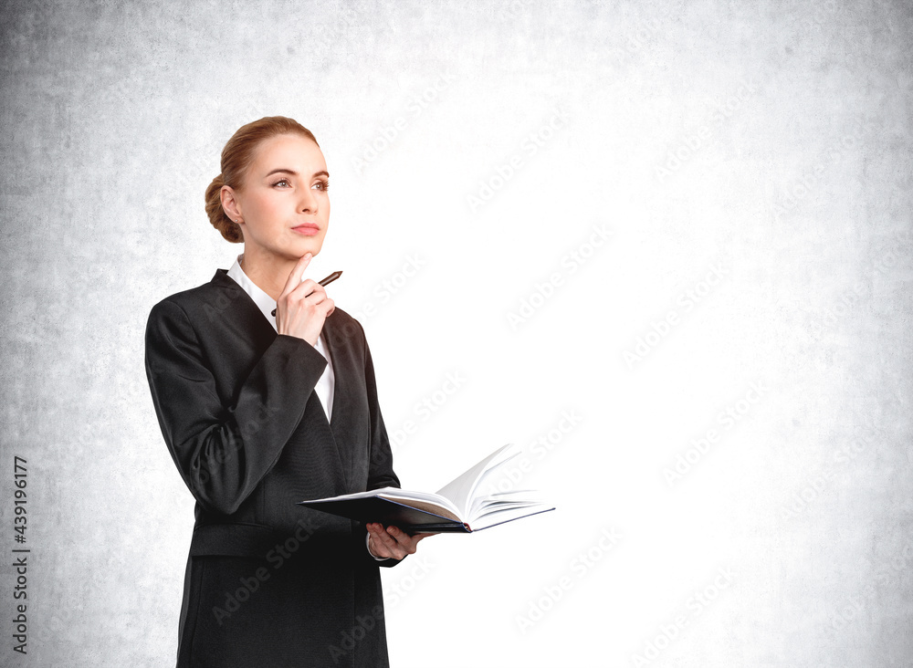 Woman with notebook standing pensive on grey background, mockup empty wall Woman with notebook standing pensive on grey background, mockup empty wall