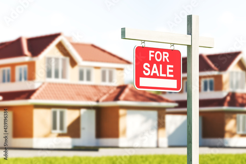 Houses for sale, red sign in front of blurred modern big building on grass