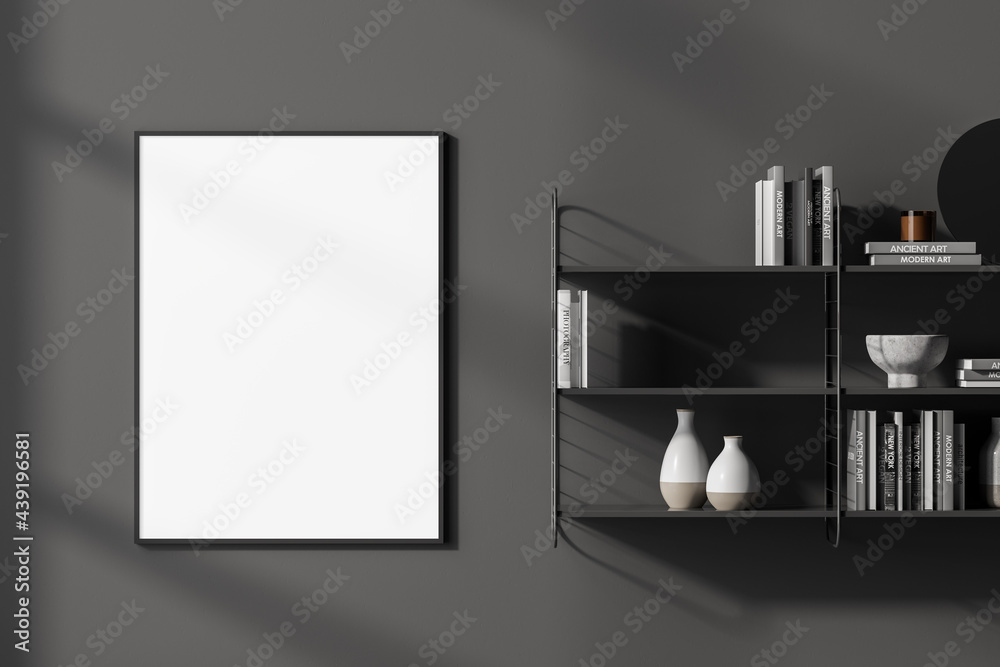 Grey bookshelves next to vertical mock up poster frame