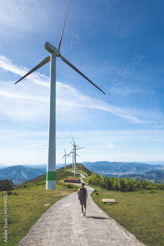 Young caucasian man near windmills at the top of Oiz mountain; Basque Country. photo