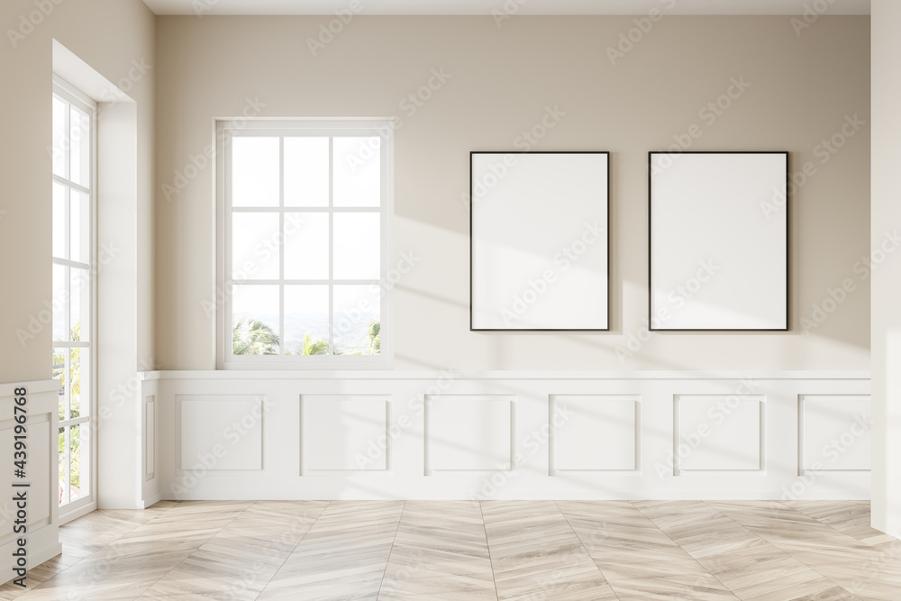 Two vertical framed mock up posters in empty white room with windows