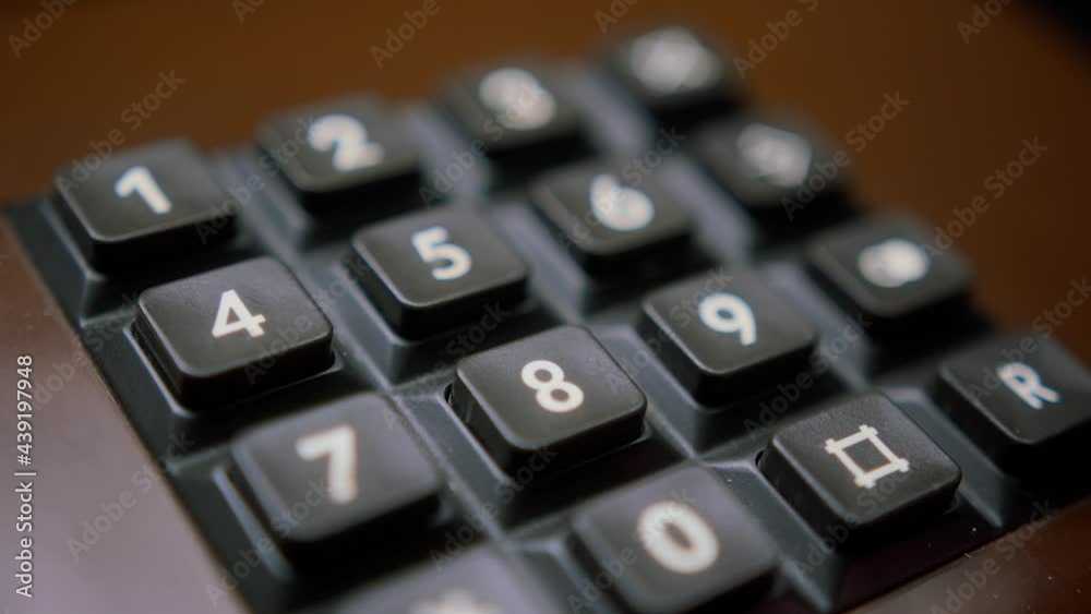 Female hand calling a phone number on old and retro brown telephone headset isolated on black background, woman hands with manicure on fingers taking typing numbers. Female hand calling a phone number on old and retro brown telephone headset isolated on black background, woman hands with manicure on fingers taking typing numbers.