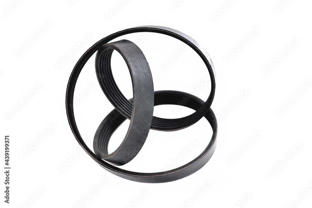 A new belt for a poly-V-ribbed electric generator. Car timing belt. White background close-up A new belt for a poly-V-ribbed electric generator. Car timing belt. White background close-up