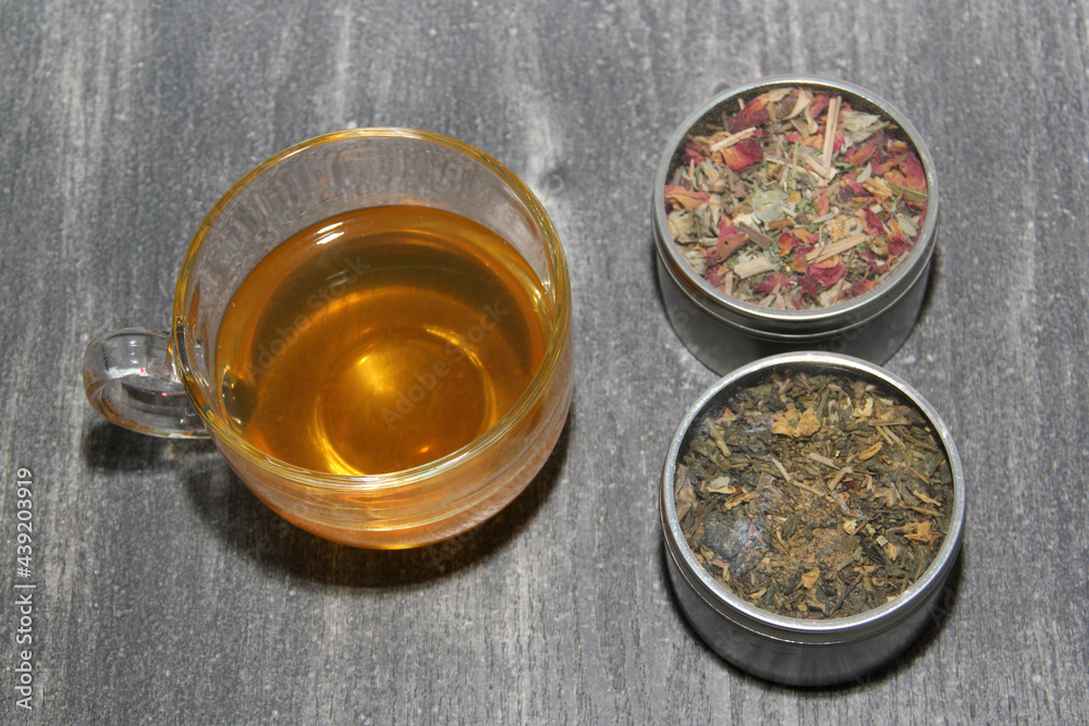 Tools for preparing herbal infusions: glass cup, infuser, spoon, dried dehydrated herb to relax or cure diseases
Tools for preparing herbal infusions: glass cup, infuser, spoon, dried dehydrated herb to relax or cure diseases