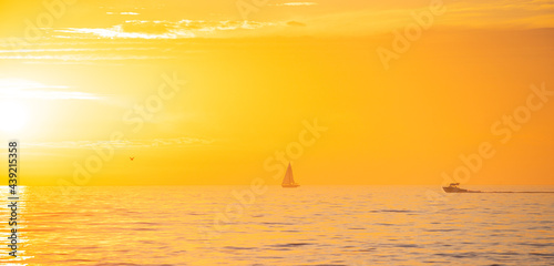 Ocean sunset on sky background with colorful clouds. Calm sea with sunrise sky.