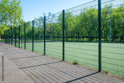 Green fence between the football field. © Prikhodko