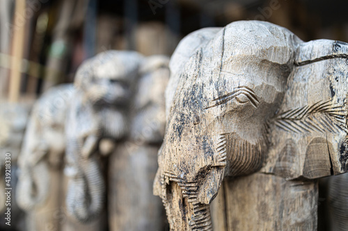 Heads of elephants calved fom old teak wood.
