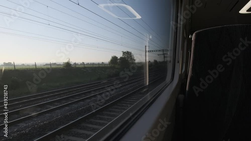 Looking out the window of high speed train at english countryside early morning empty seat photo