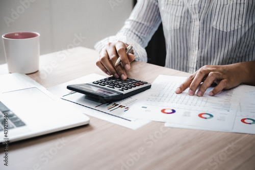Business Accountant Woman Analysis Finance Accounting Budget Report at Her Office Desk. Professional Financial Manager Planning to Strategy and Account Cost Saving for Company Project Investment.