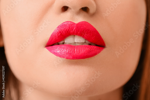 Beautiful young woman with bright lipstick  closeup