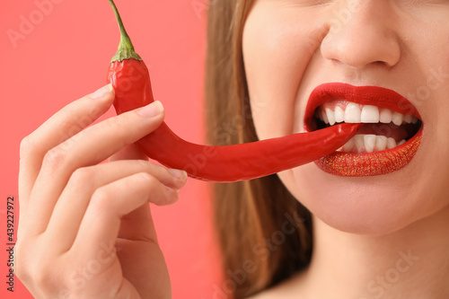 Sexy young woman with chili...