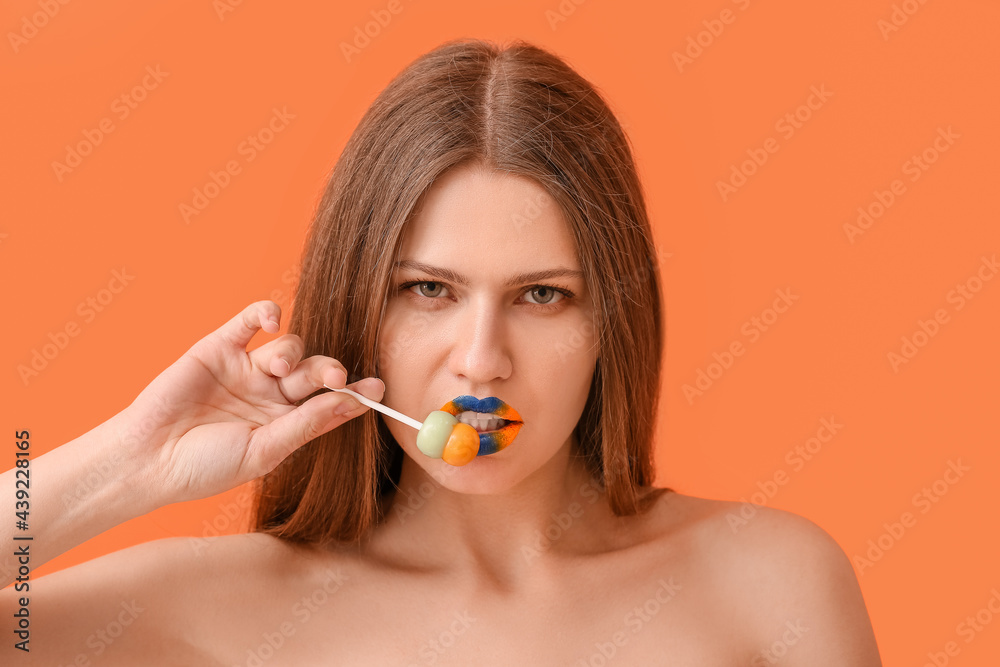 Beautiful young woman with creative makeup and lollipop on color background Beautiful young woman with creative makeup and lollipop on color background