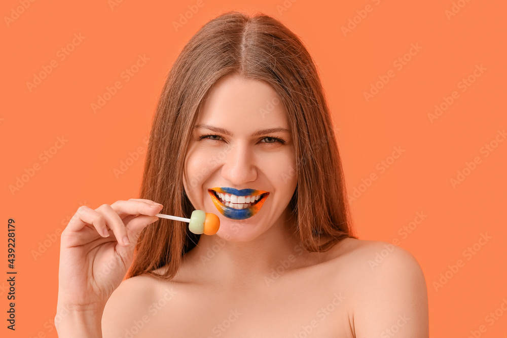 Beautiful young woman with creative makeup and lollipop on color background Beautiful young woman with creative makeup and lollipop on color background