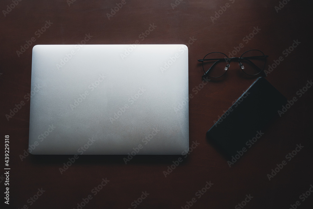 Empty tablet with smartphone and glasses on desk. Business and finance concept. Workplace, Flat lay with blank copy space.