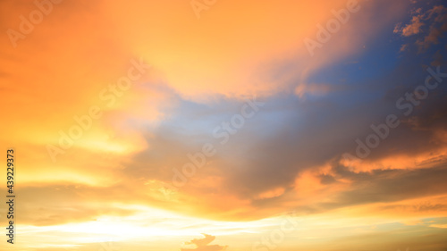 Background of orange sky and clouds with sunset light in evening at summer time when with blank copy space, showing about environment, climate concept. © Bangkok Click Studio