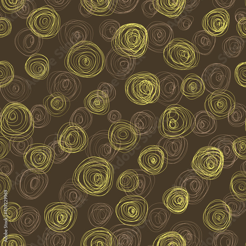 Abstract pattern of light yellow circles drawn with a thin swirling line on a brown background. Nice print for clothes.Seamless pattern