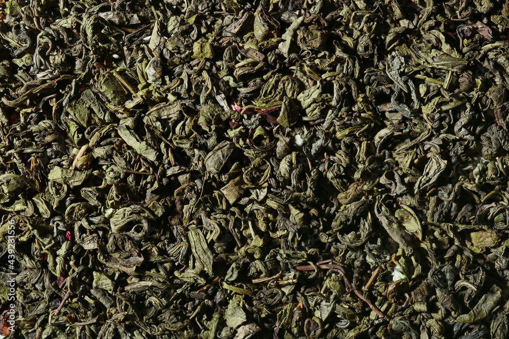 Dry green tea leaves as background, closeup Dry green tea leaves as background, closeup