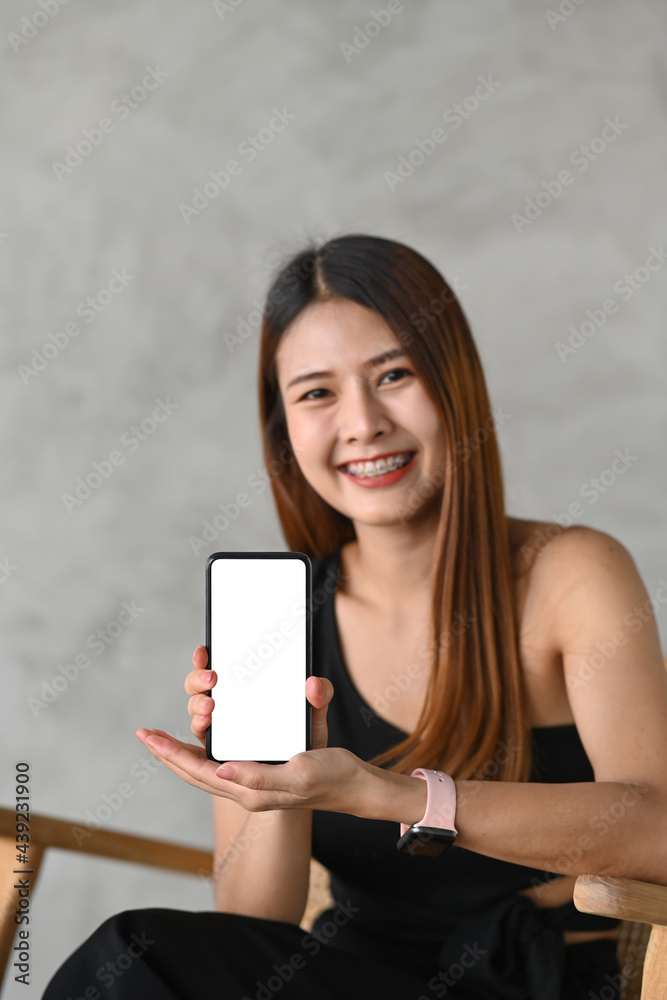 Portrait of young asian woman showing smart phone with empty screen. Portrait of young asian woman showing smart phone with empty screen.