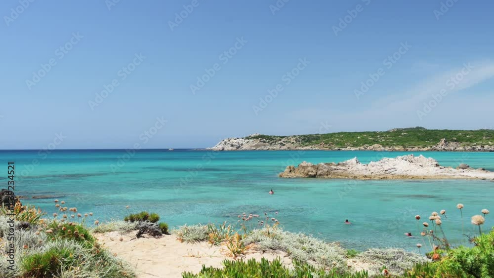 (Selective focus) Stunning view of a coastline bathed by a turquoise, clear sea. Rena Majore is a small seaside village that's located south of Santa Teresa Gallura, Sardinia, Italy. (Selective focus) Stunning view of a coastline bathed by a turquoise, clear sea. Rena Majore is a small seaside village that's located south of Santa Teresa Gallura, Sardinia, Italy.