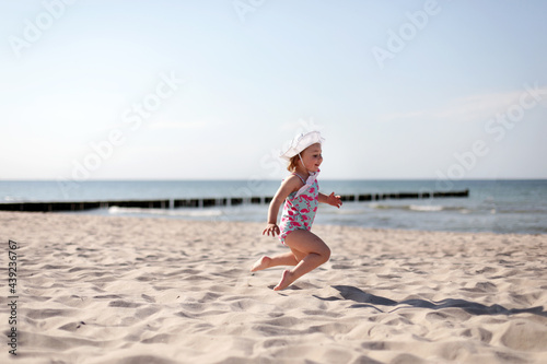 Happy smiling little girl on beach vacation