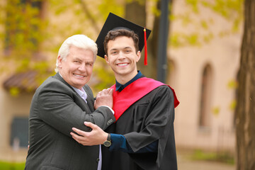 Happy young man with his father on graduation day