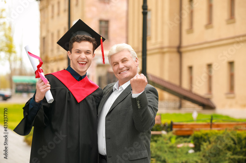 Happy young man with his fa...