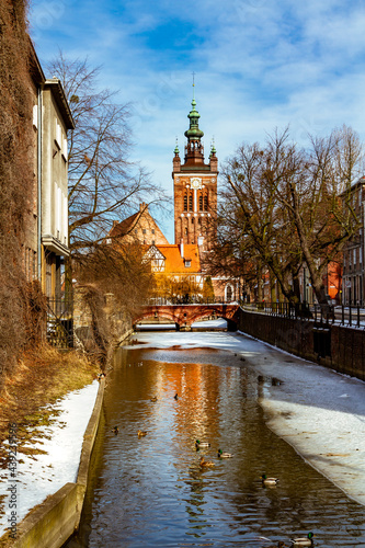 Radunia Canal and St. Catherine church. Old city of Gdansk (Danzig) in winter scenery. Gdansk, Pomerania, Poland photo
