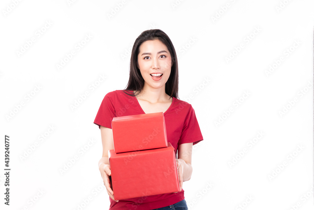 Asian women holding red present box. Portrait of happy smiling Asian girl in casual clothing holding gift box isolated on white. Happy pretty Asian woman holding red gift box on white background. Asian women holding red present box. Portrait of happy smiling Asian girl in casual clothing holding gift box isolated on white. Happy pretty Asian woman holding red gift box on white background.