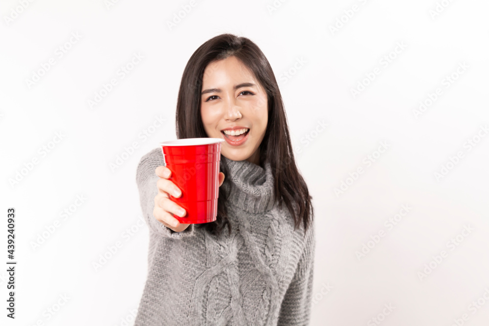 Happy Asian Woman holding cold glass of beer. Young female celebrating hold red plastic cup of cola or soda isolated on white background. Beautiful smiling woman holding beer glass while standing. Happy Asian Woman holding cold glass of beer. Young female celebrating hold red plastic cup of cola or soda isolated on white background. Beautiful smiling woman holding beer glass while standing.