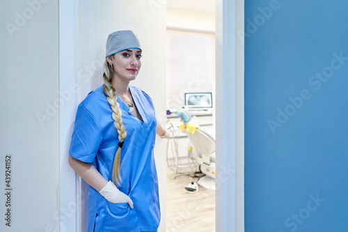 female dentist opening the office door to a patient. Concept, medicine - health