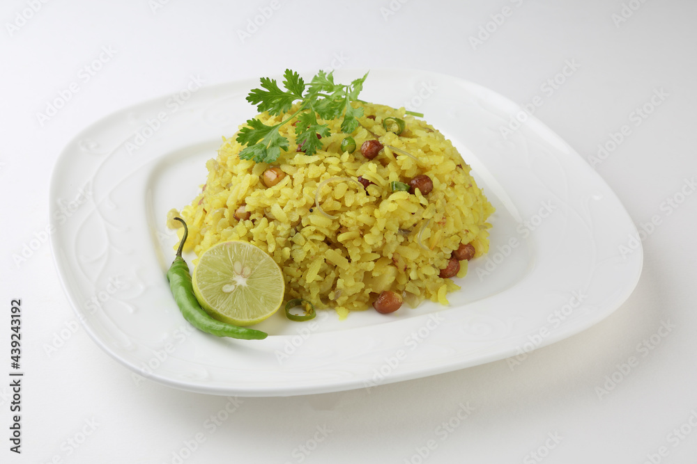 Indian Breakfast Dish Poha Also Know as Pohe or Aalu poha made up of Beaten Rice or Flattened Rice. The rice flakes are lightly fried in oil with mustard, turmeric, onion, curry leaves Indian Breakfast Dish Poha Also Know as Pohe or Aalu poha made up of Beaten Rice or Flattened Rice. The rice flakes are lightly fried in oil with mustard, turmeric, onion, curry leaves