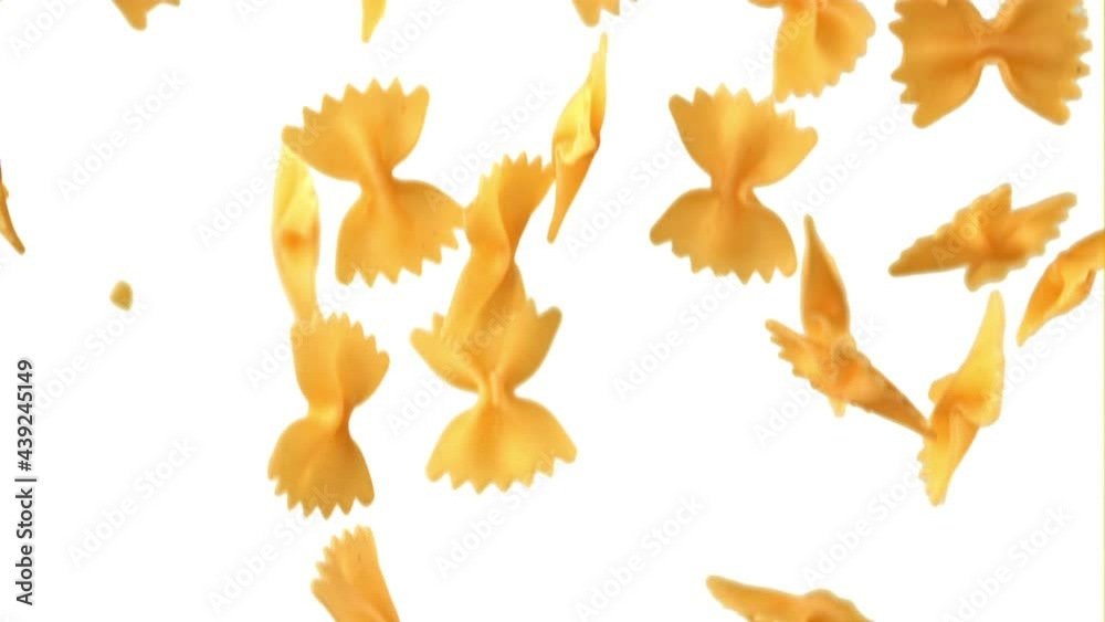 Super slow motion farfalle paste dry falls. On a white background. Filmed on a high-speed camera at 1000 fps. High quality FullHD footage Super slow motion farfalle paste dry falls. On a white background. Filmed on a high-speed camera at 1000 fps. High quality FullHD footage