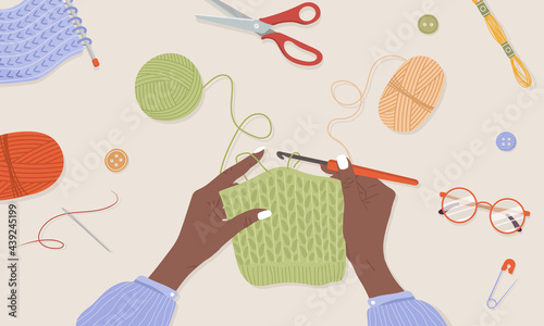 Crochet knitting process. African female hands with hook and thread. Balls of yarn. Top view of the workplace. Tailor shop elements. Hand drawn vector illustration in flat cartoon style.