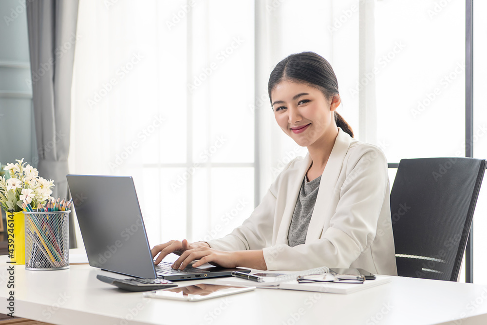 Asian working woman is working on her labtop Working from home with relax. Working at the office. Asian working woman is working on her labtop Working from home with relax. Working at the office.