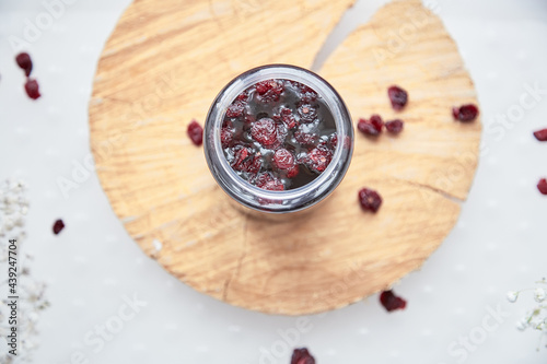 Healthy fermented honey product with cranberry. Food preservative at home, cozy, rustic flat lay. Fermentation process. Delicious recipe concept. Anti-viral food.