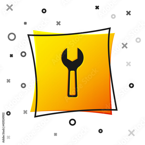 Black Wrench spanner icon isolated on white background. Yellow square button. Vector
