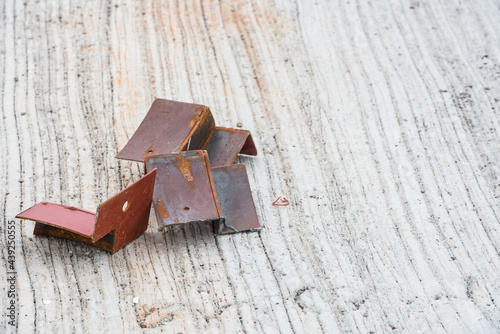 .Several pieces of scrap iron rods placed on the concrete floor.