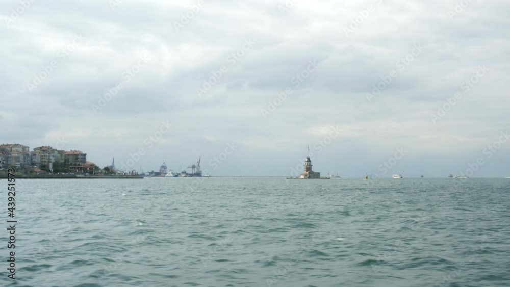 Scenic view of Bosphorus and Maiden Tower from sea. Amazing view of Kiz Kulesi Tower and Bosphorus at cloudy day Scenic view of Bosphorus and Maiden Tower from sea. Amazing view of Kiz Kulesi Tower and Bosphorus at cloudy day